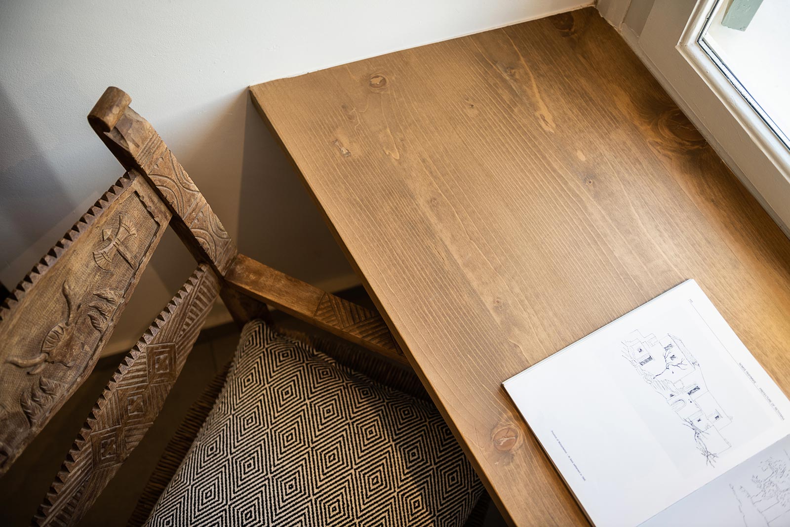 Hotel bedroom interior, wooden chair in front of the window